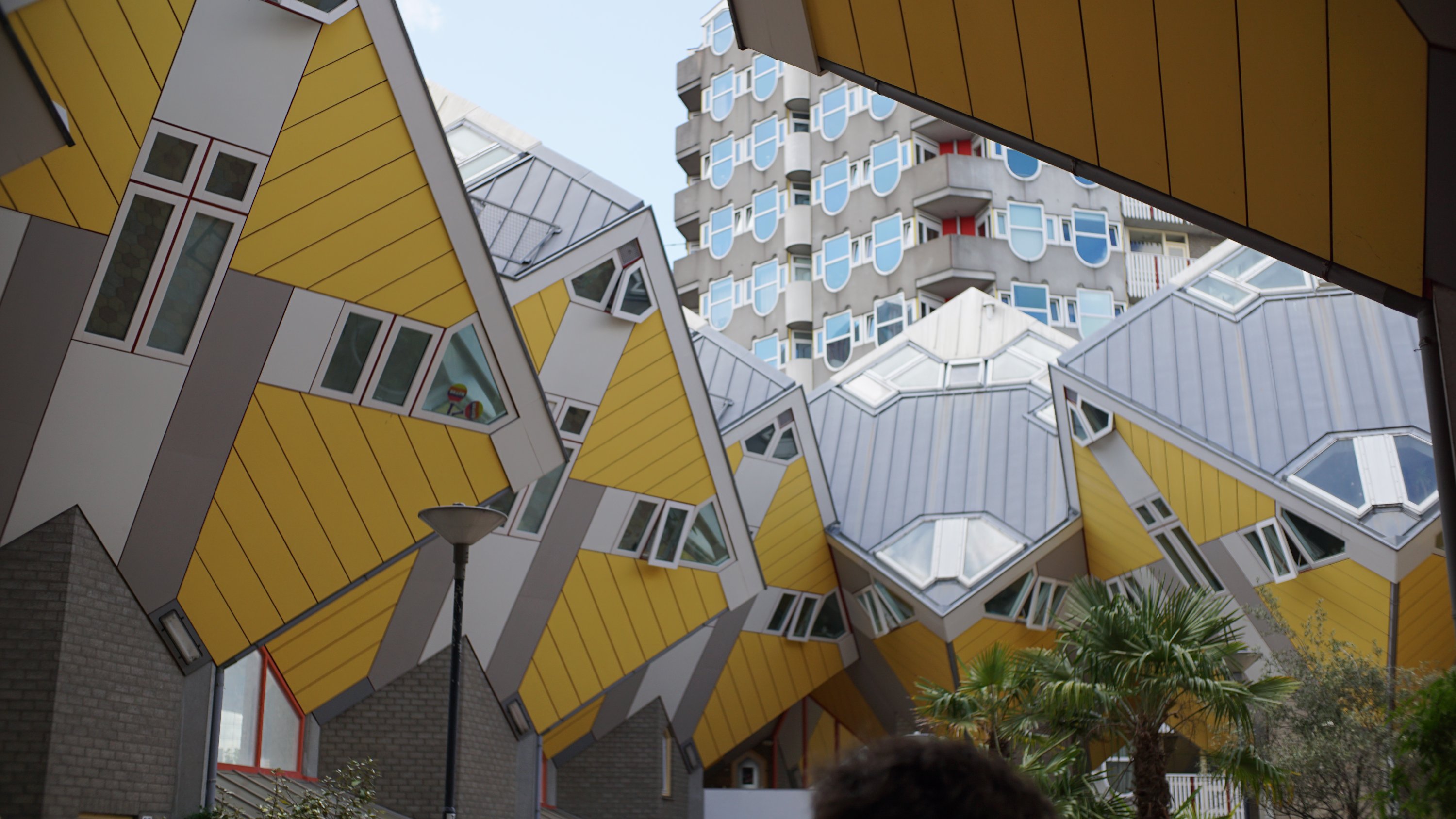 Würfelhäuser aus deren Mitte nach oben geblickt 