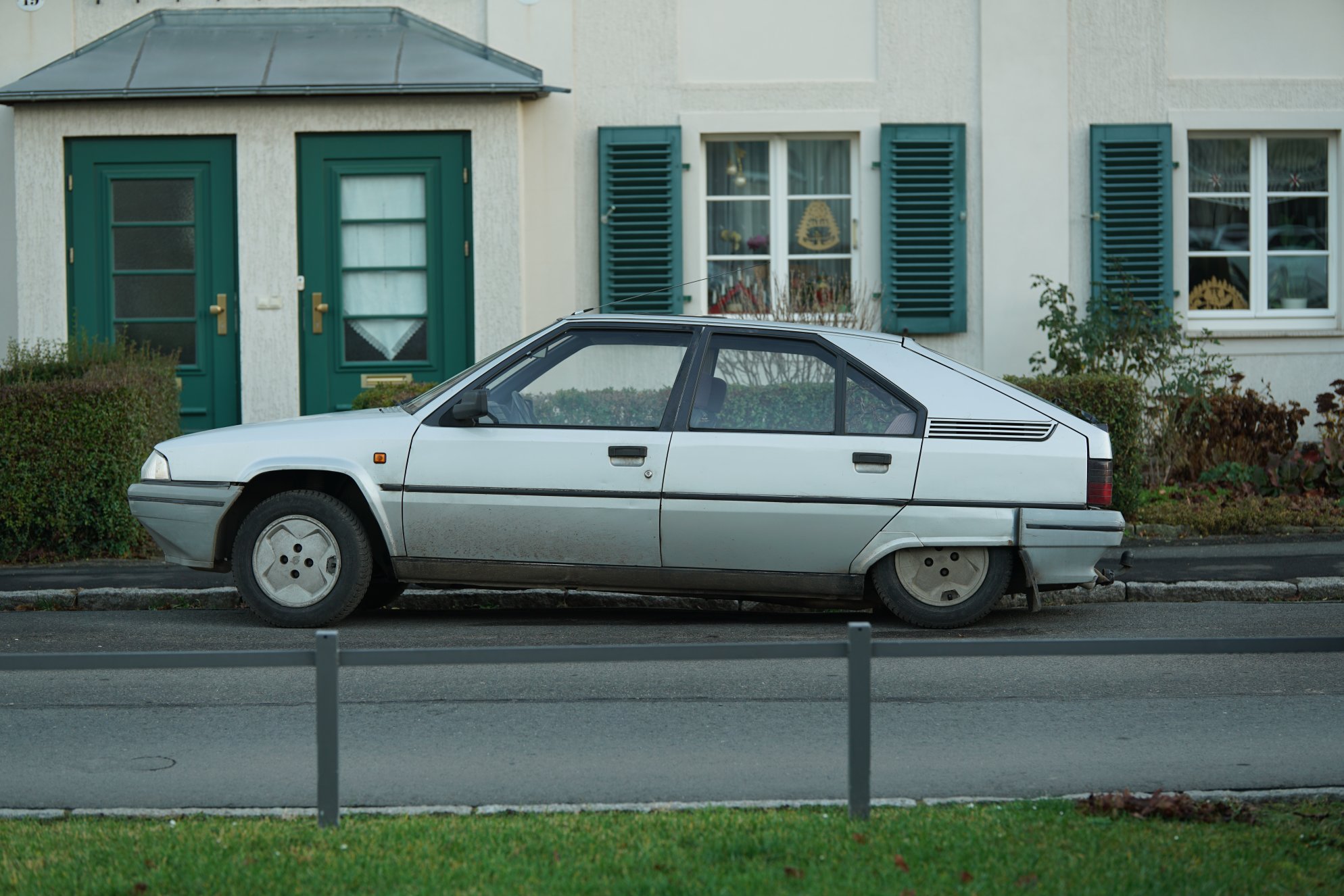 Ein älterer PKW (locker mehr als 25 Jahre) der hinten SEHR tief hängt.